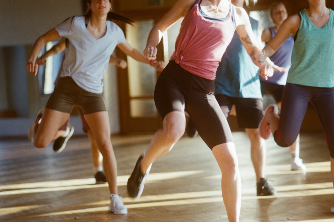 group of women running on brown wooden floor — Foto por Kaspars Eglitis na Unsplash